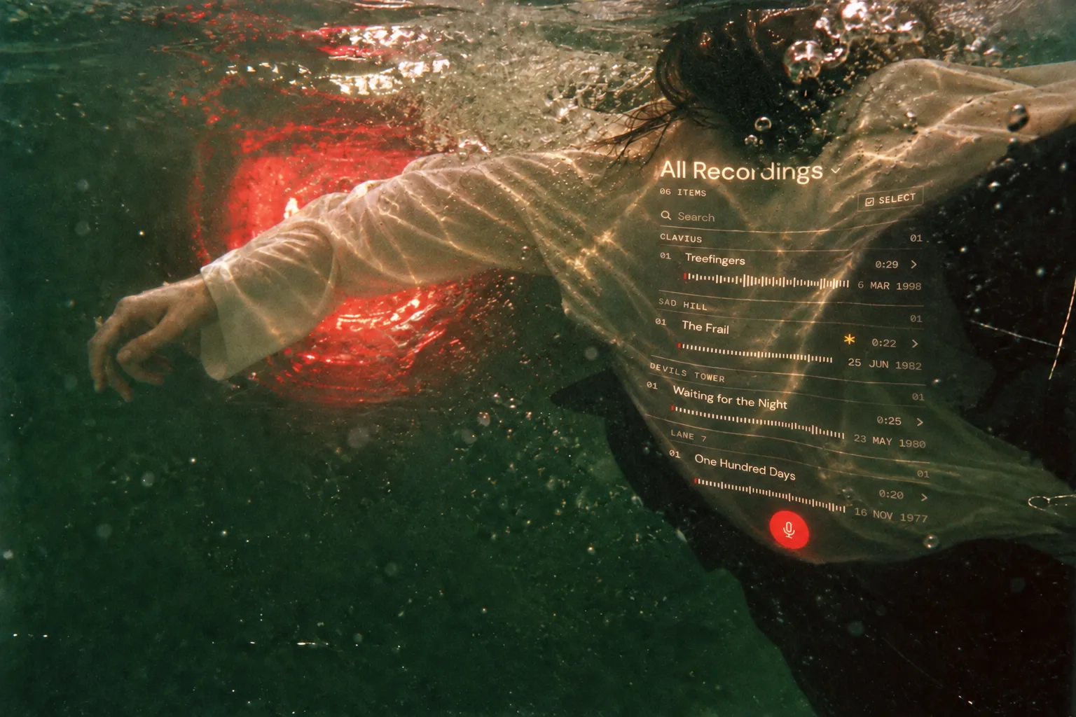 A swimmer underwater in a pale shirt, with the Music Dawn library projected across the fabric.